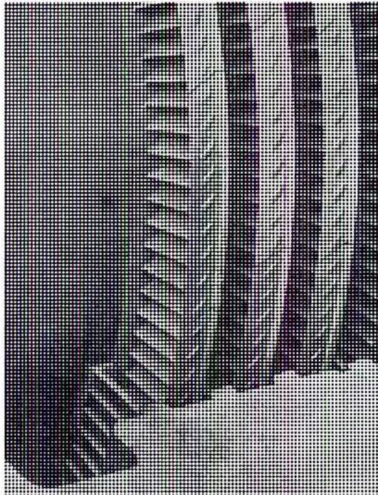Close-up photograph of shrouded built-up reaction blading, showing a series of blades with a top shroud.