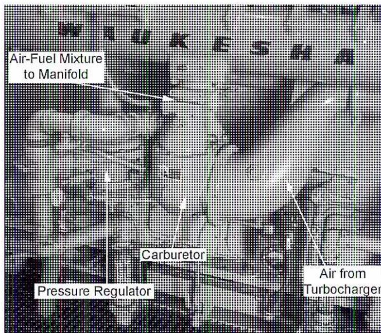 Figure 13: A photograph of a carburetor assembly for a natural gas engine. Labels point to the 'Air-Fuel Mixture to Manifold', the 'Carburetor' body, a 'Pressure Regulator', and 'Air from Turbocharger'.