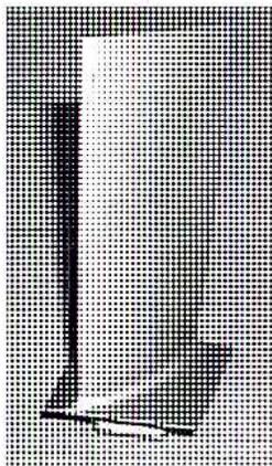 A black and white photograph of a single gas turbine blade, showing its airfoil shape and the root section.