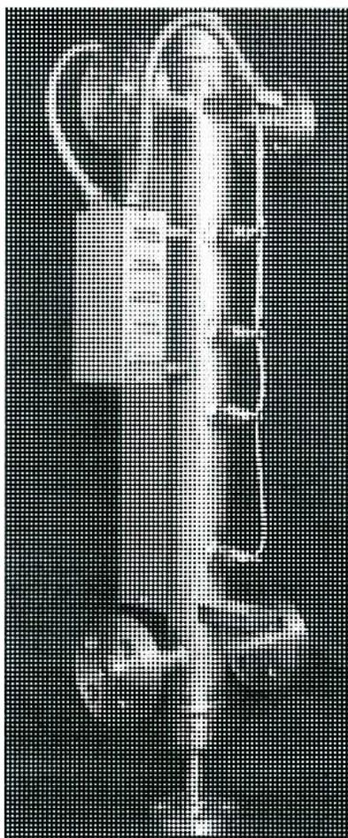 A black and white photograph of a vertical, cylindrical Multi-Probe Conductivity Column. The column has several horizontal bands or rings around its body, likely representing the discrete measuring cells. It is mounted on a dark, textured background.