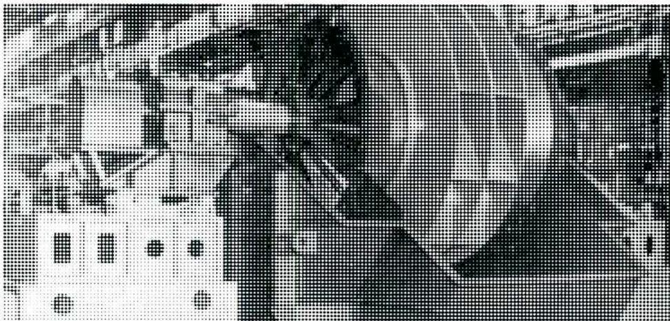 A black and white photograph of a centrifugal fan rotor. The rotor features a series of curved blades, identified as airfoil blading, mounted on a central hub. The blades are arranged in a circular fashion, and the overall structure is robust, typical of industrial fan components.