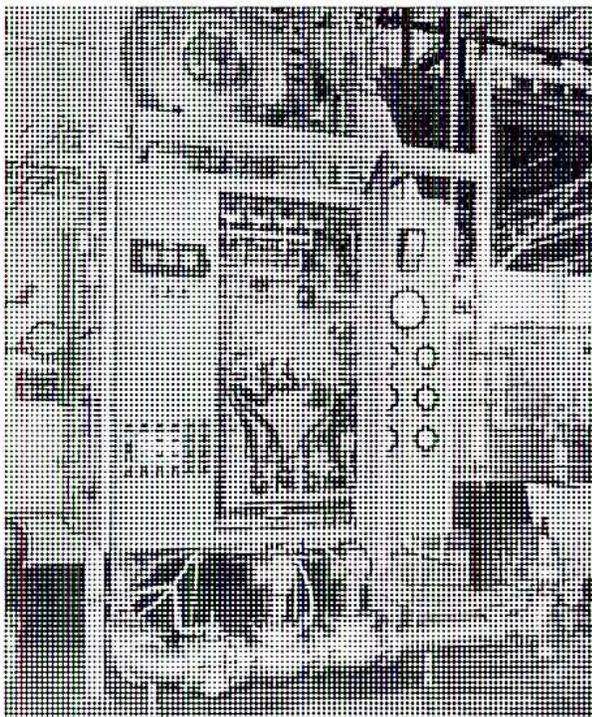 A black and white photograph of a boiler control panel. The panel is rectangular and contains various components: several analog gauges with needles and scales, a large pushbutton, a series of indicator lights, and a rectangular display area for an alarm annunciator. The layout is organized with labels for each component.
