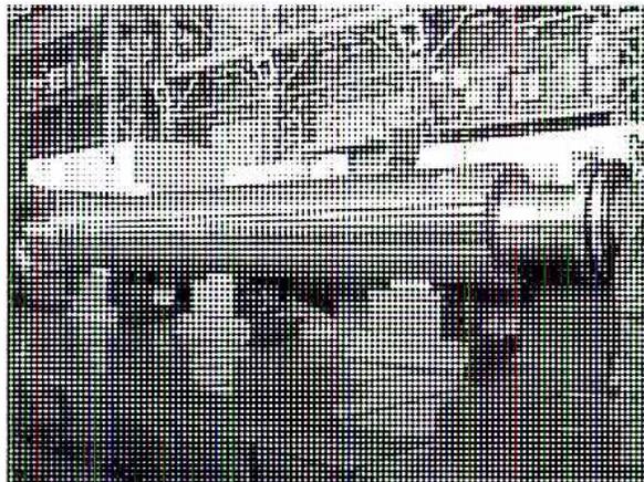 Figure 6: A black and white photograph of a very large, long cylindrical rotor lying horizontally on a support structure in a factory or workshop.